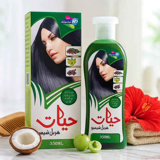 Hayat Herbal Shampoo 350ml bottle and box with coconut, amla, hibiscus flower, and wooden comb on a clean background.