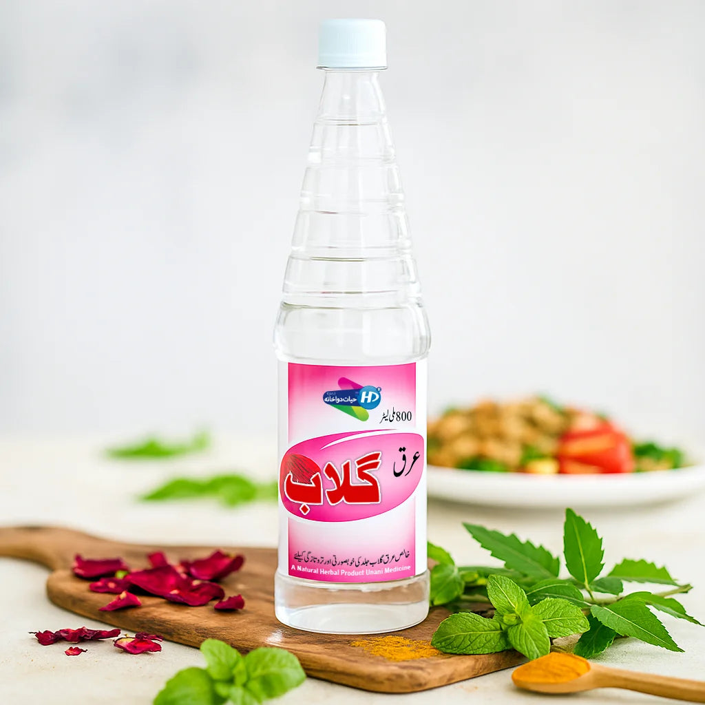 Hayat Dawakhana Arq e Gulab rose water shown with rose petals mint and herbal elements in a fresh natural wellness background.