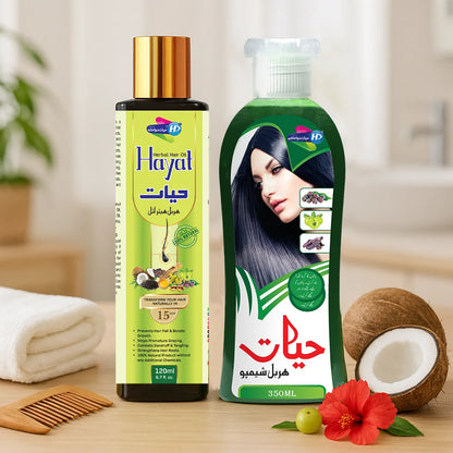 Hayat Herbal Shampoo and Hayat Herbal Hair Oil bundle placed with coconut, hibiscus flower and amla on a wooden surface.