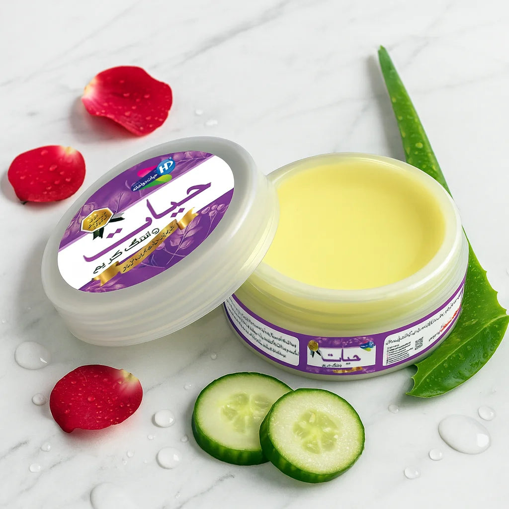 Hayat Whitening Cream open jar with cucumber slices, aloe vera leaf and rose petals on marble background.