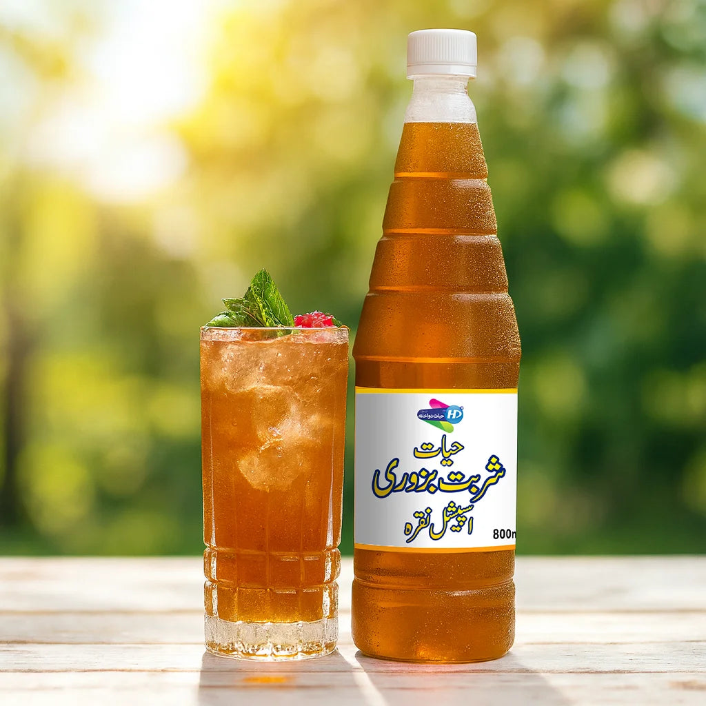 Bottle of Sharbat Bazoori with a glass of ice drink garnished with mint and berries on an outdoor wooden table.