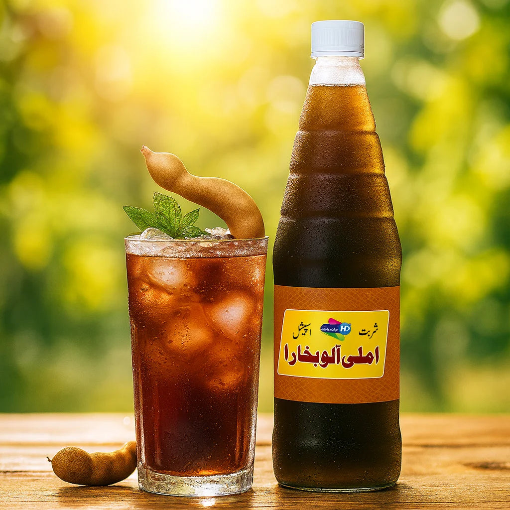Sharbat Imli Alu Bukhara bottle with a chilled tamarind drink and fresh tamarind pods on a wooden table in a bright outdoor setting.