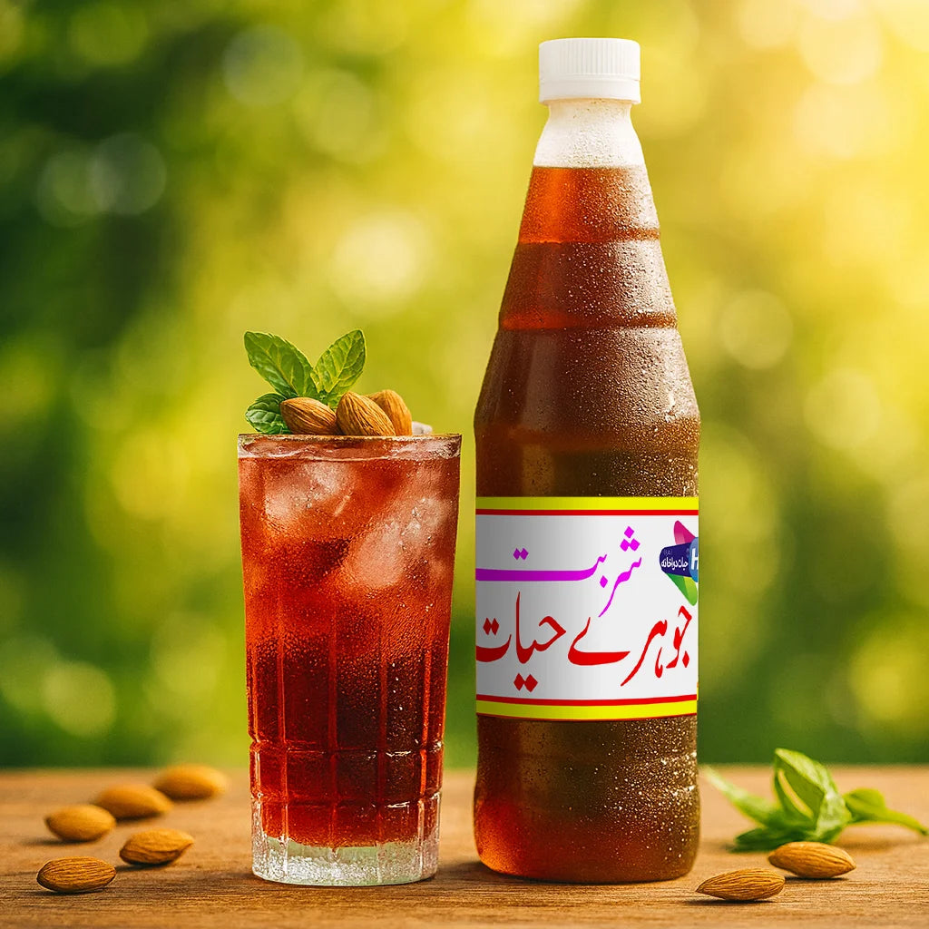 Sharbat Johar-e-Hayat bottle beside a glass of iced red drink topped with almonds and mint leaves, with almonds scattered on the wooden table in natural sunlight.