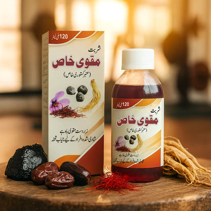 Sharbat Muqawi Khas Amber Kastori herbal tonic bottle and packaging displayed with saffron, dates, ginseng roots, and natural ingredients in a warm indoor setting.