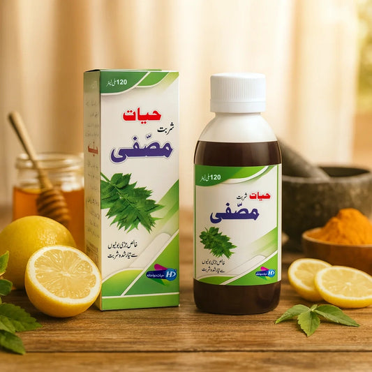 Hayat Sharbat Musaffi bottle and box with neem leaves, lemon and honey displayed on a wooden table for blood cleansing and skin health.
